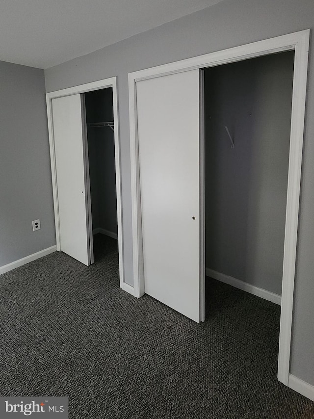 unfurnished bedroom featuring dark colored carpet