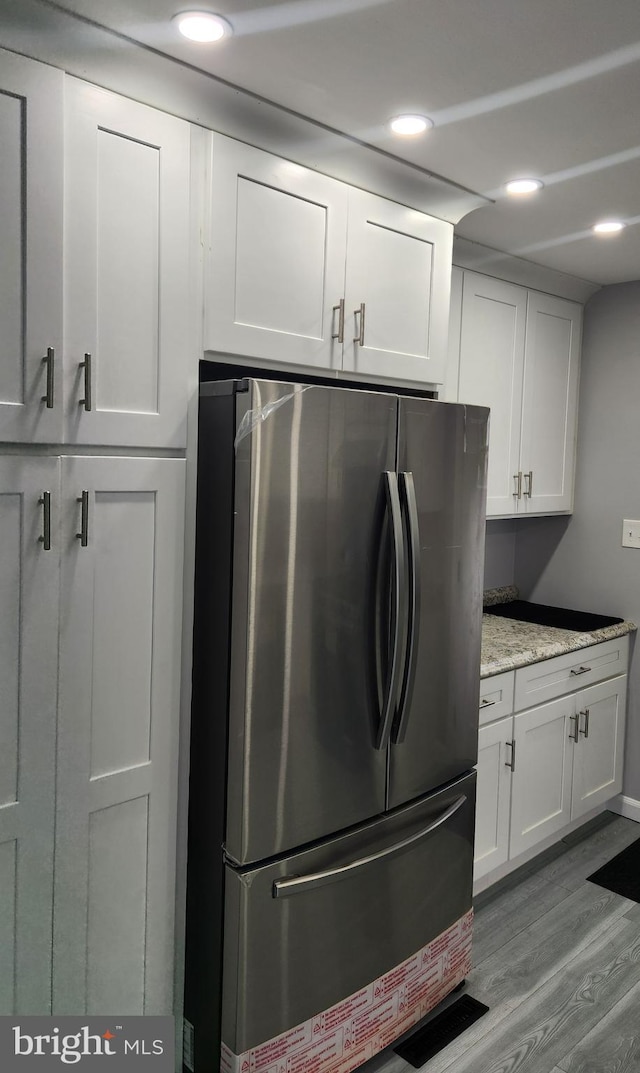 laundry room featuring light wood-type flooring