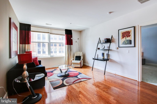 living area with hardwood / wood-style floors