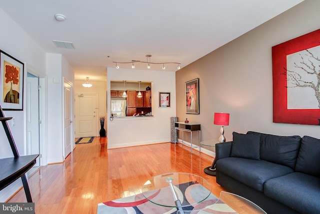 living room with light hardwood / wood-style flooring