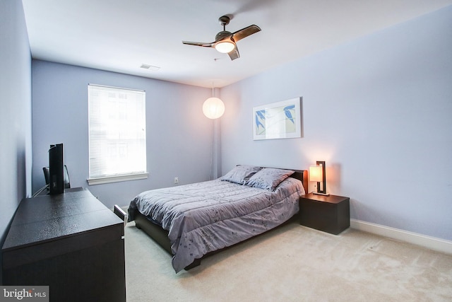 bedroom featuring light carpet and ceiling fan