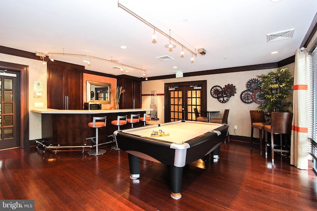 recreation room with bar area, billiards, dark hardwood / wood-style flooring, ornamental molding, and french doors