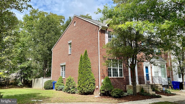 view of side of property with a yard