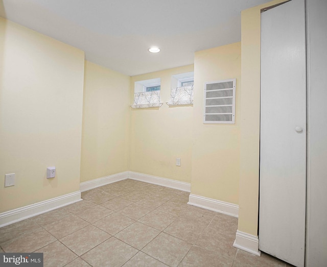 basement featuring light tile patterned flooring