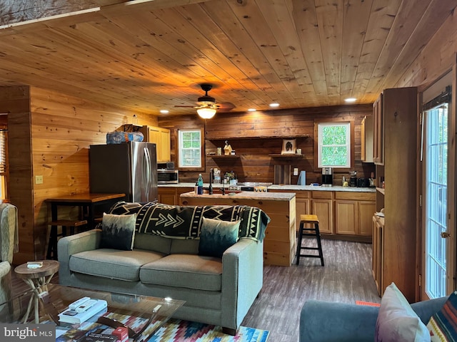 living room with wooden ceiling, dark hardwood / wood-style flooring, ceiling fan, and plenty of natural light