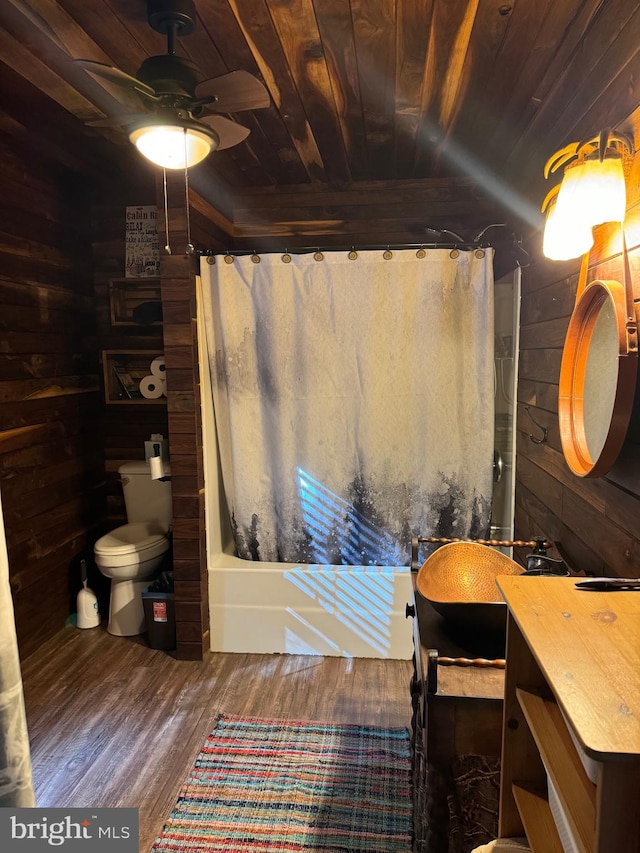 full bathroom with wood ceiling, wood walls, ceiling fan, vanity, and toilet