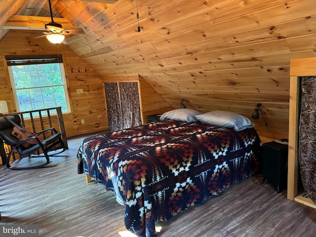 bedroom with wood ceiling, vaulted ceiling, ceiling fan, hardwood / wood-style flooring, and wooden walls