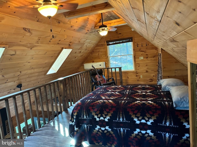 bedroom featuring wood ceiling, lofted ceiling with skylight, wooden walls, and ceiling fan