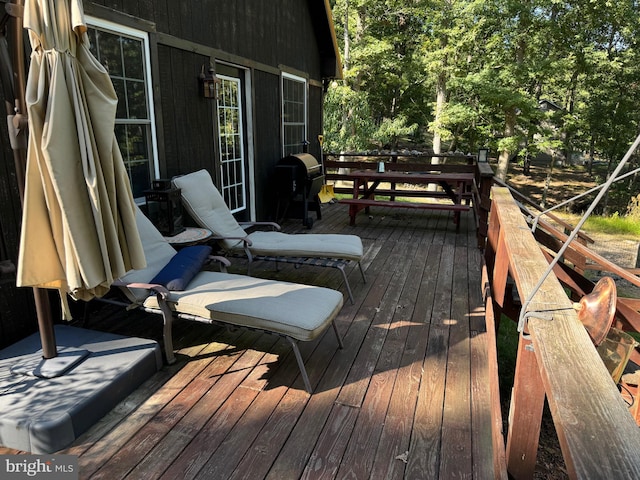 wooden terrace with a grill