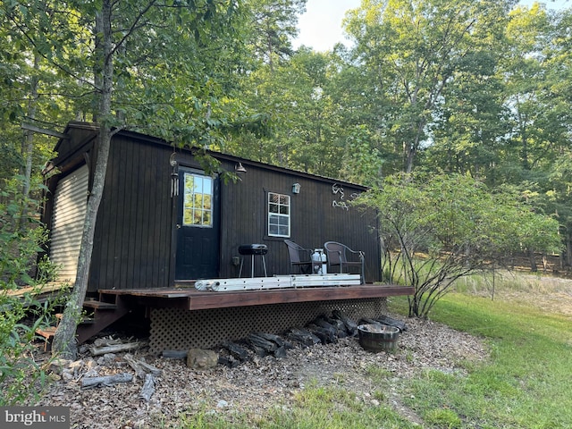 back of house featuring a wooden deck