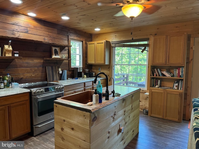 kitchen with dark hardwood / wood-style floors, sink, electric stove, a center island with sink, and ceiling fan