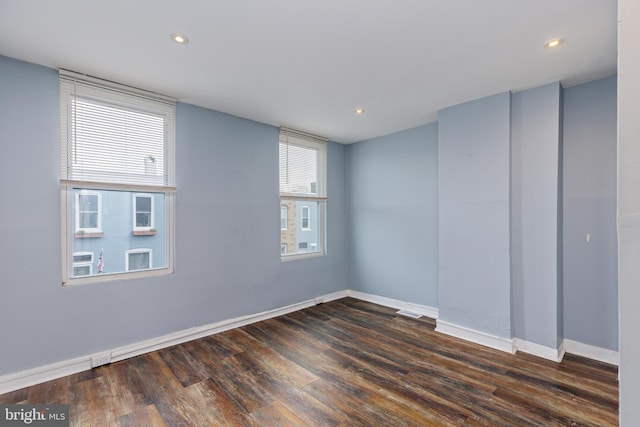 empty room with dark wood-type flooring