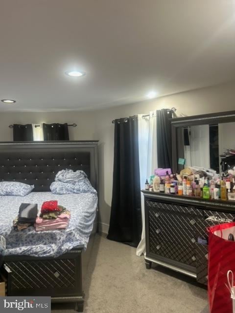 bedroom featuring light colored carpet