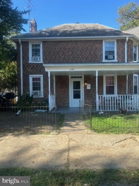 view of front of property with cooling unit and a porch