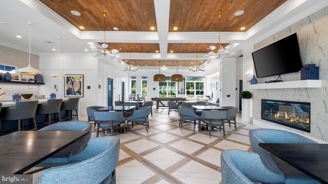 living room with pool table, a fireplace, a notable chandelier, and wooden ceiling