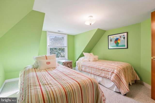 bedroom with vaulted ceiling and carpet flooring