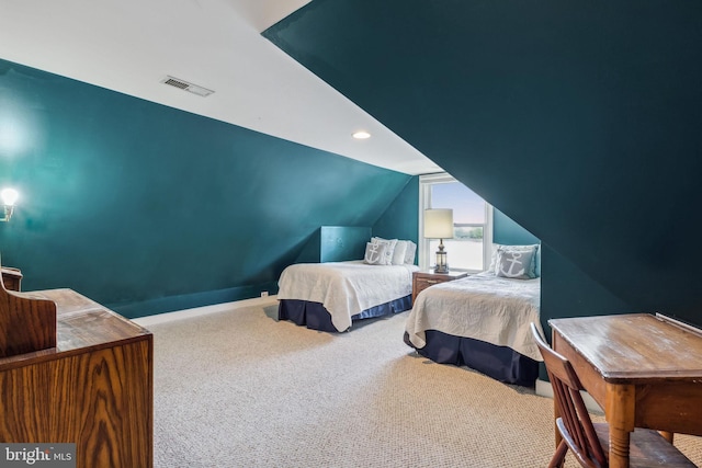 carpeted bedroom with lofted ceiling