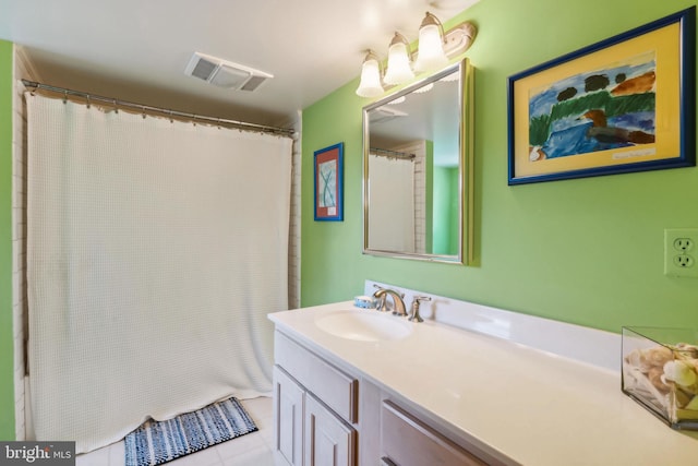 bathroom featuring vanity, tile patterned flooring, and a shower with shower curtain