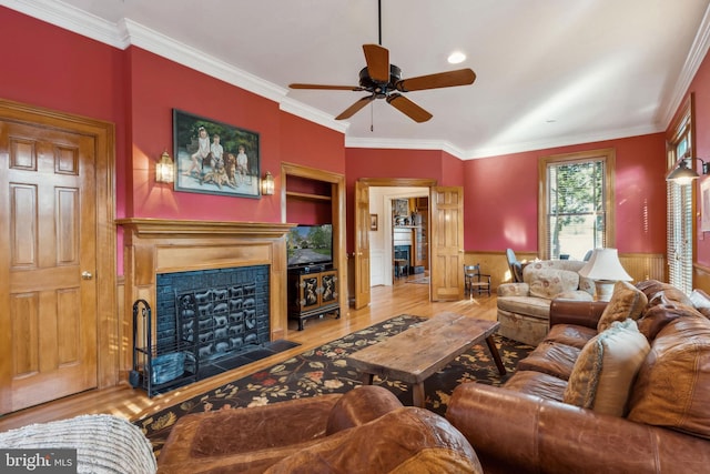 living room with light hardwood / wood-style flooring and ornamental molding