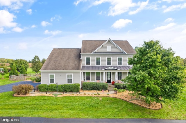 view of front of home with a front yard and a porch