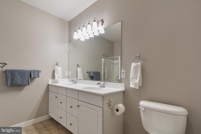 bathroom featuring vanity, tile patterned floors, toilet, and an enclosed shower