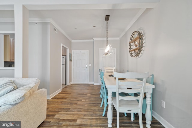 dining space with crown molding and dark hardwood / wood-style flooring