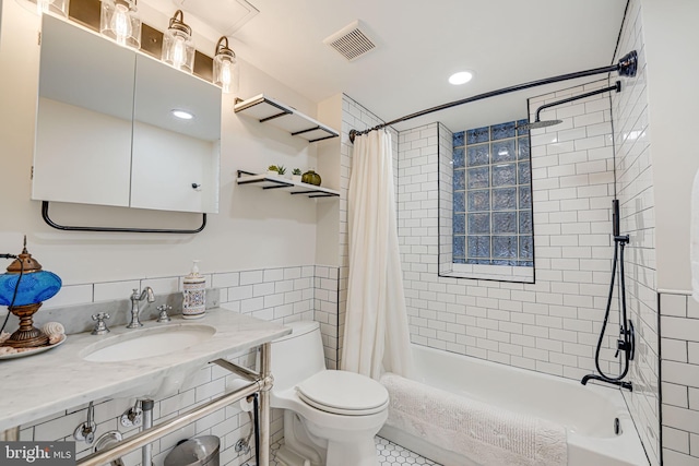 full bathroom featuring tile walls, tile patterned flooring, shower / bath combo, vanity, and toilet