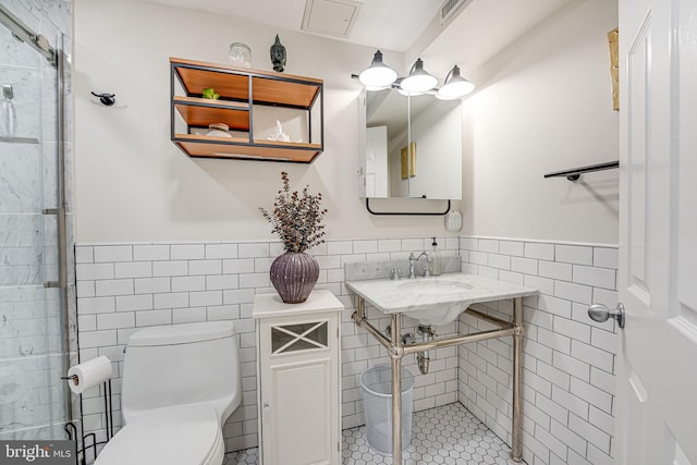 bathroom with walk in shower, tile walls, toilet, and tile patterned floors