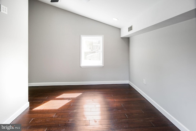 unfurnished room with lofted ceiling and dark hardwood / wood-style floors