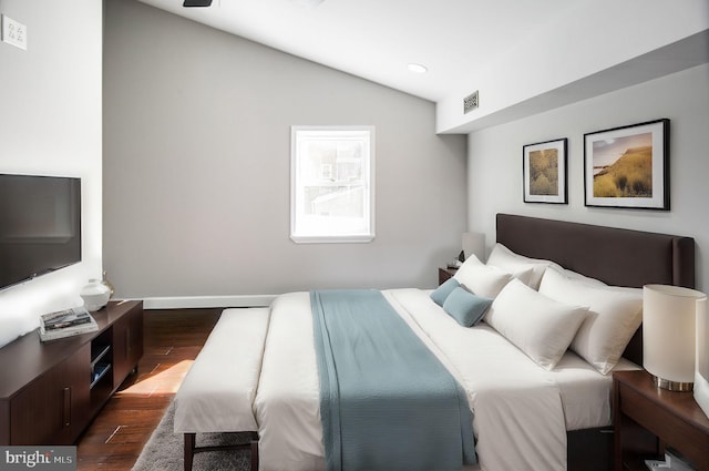 bedroom with dark hardwood / wood-style floors and vaulted ceiling