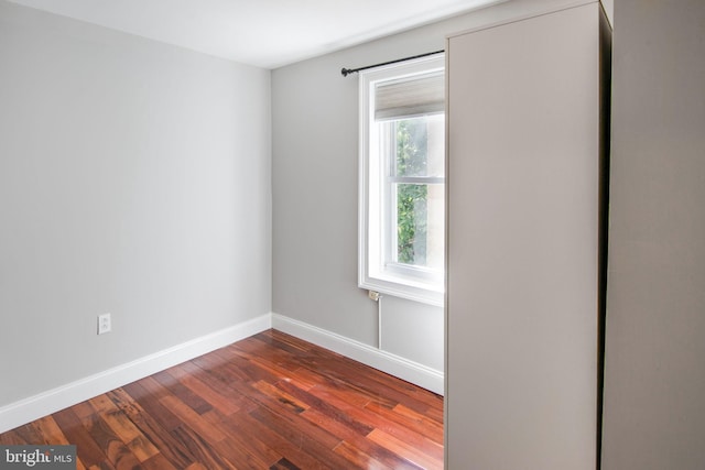 unfurnished room featuring dark hardwood / wood-style flooring