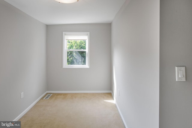 spare room with light colored carpet