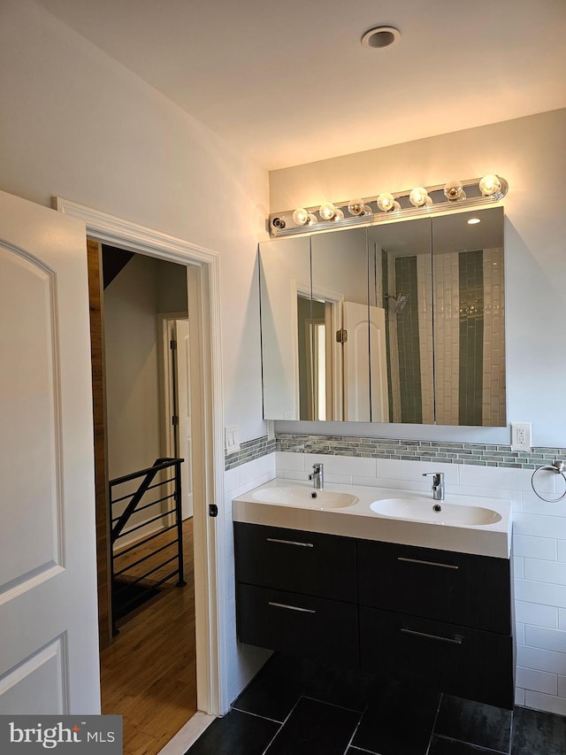 bathroom with wood-type flooring, a shower with curtain, vanity, and tile walls