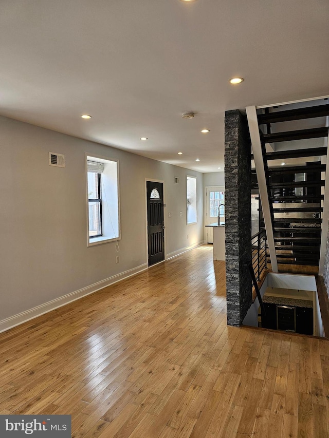 foyer entrance with light wood-type flooring and sink