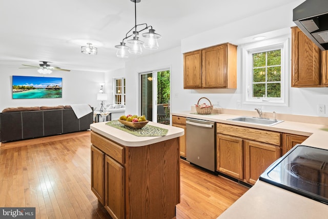 kitchen with dishwasher, light hardwood / wood-style floors, sink, range hood, and hanging light fixtures