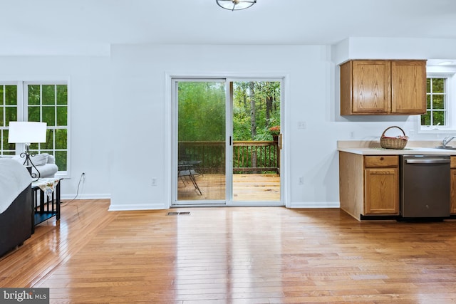 kitchen with dishwasher, light wood-type flooring, and a healthy amount of sunlight