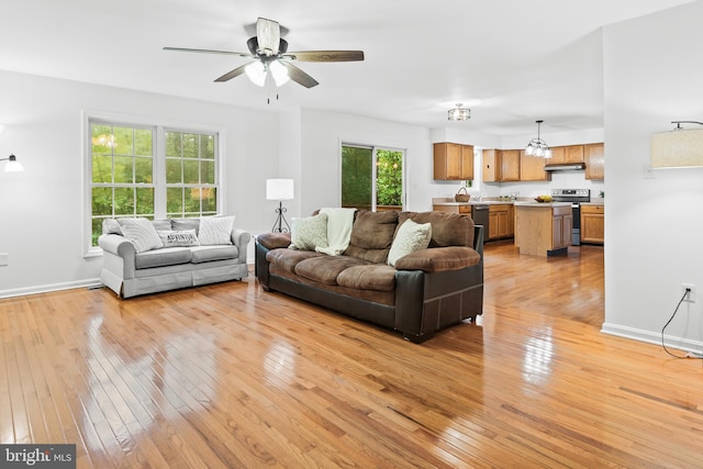 living room featuring ceiling fan and light hardwood / wood-style flooring