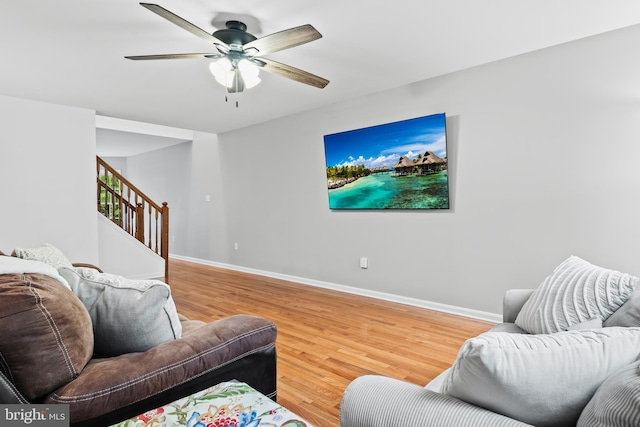 living room featuring ceiling fan and hardwood / wood-style floors