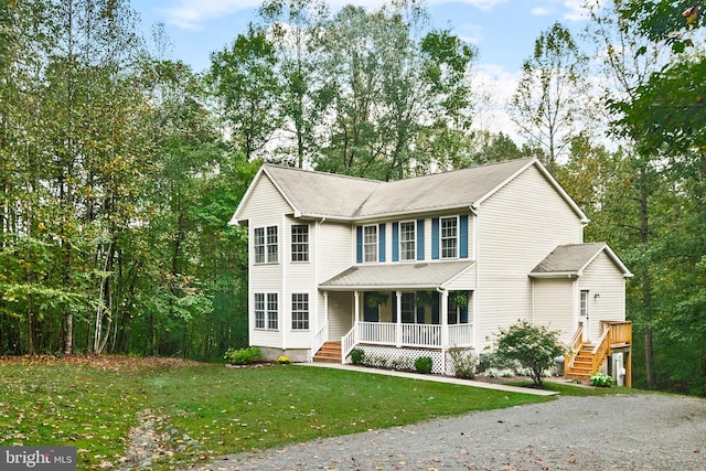 view of front of home with covered porch and a front yard