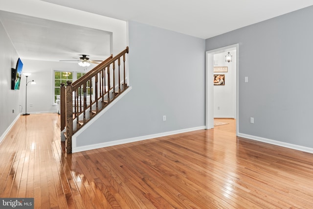 unfurnished living room with ceiling fan and light hardwood / wood-style flooring