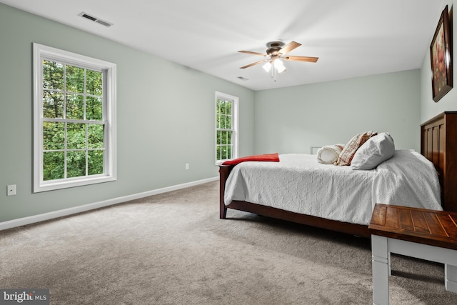 bedroom featuring ceiling fan and light colored carpet