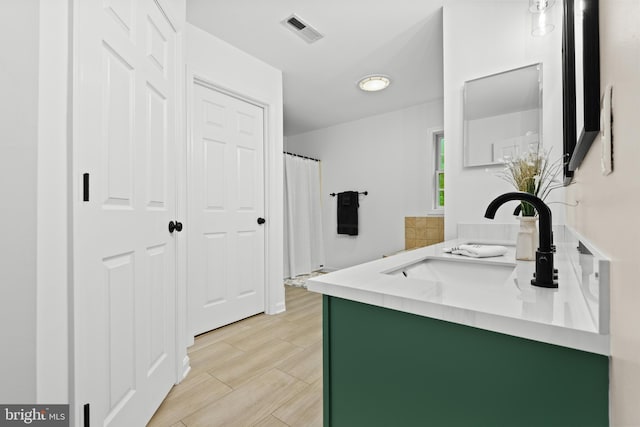 bathroom featuring wood-type flooring and vanity