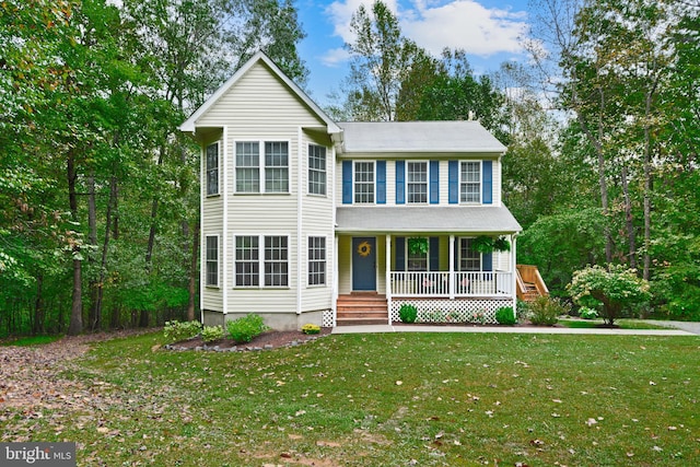 view of front of property featuring a front lawn and covered porch