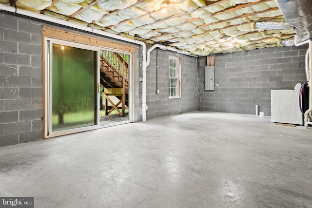 basement featuring electric panel and washer / dryer