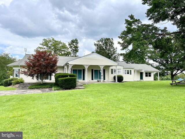 ranch-style house with a front yard and a porch