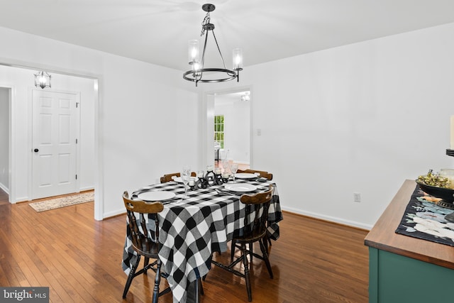 dining space with dark hardwood / wood-style flooring