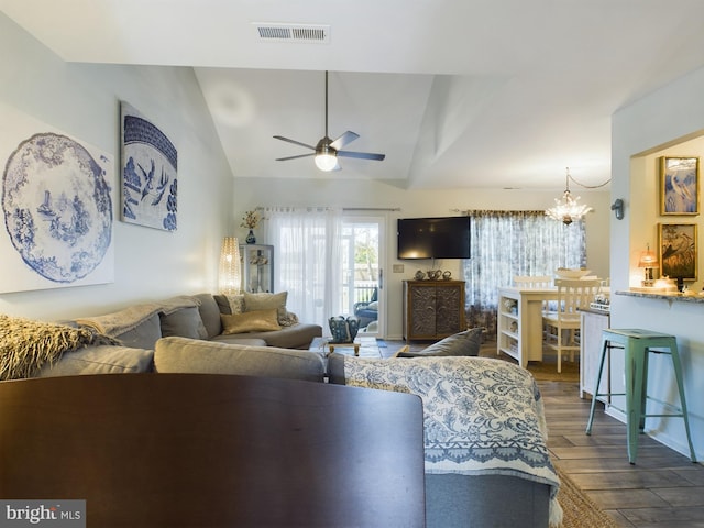 living room with ceiling fan with notable chandelier, vaulted ceiling, and dark wood-type flooring