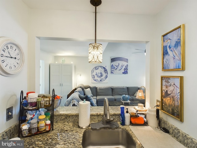 living room featuring sink and ceiling fan