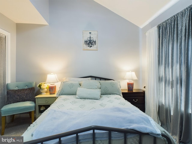 bedroom featuring lofted ceiling and carpet