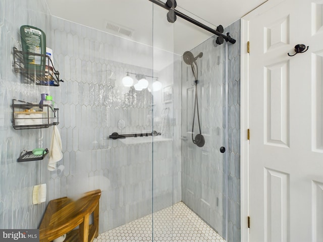 bathroom with a shower with door